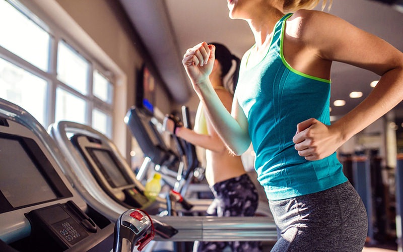 Large fitness center with plenty of equipment and large windows 